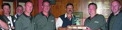 SMS were the winners. Pictured from left to right in the foreground are: Steve Niven, Paul Mulder, Piet van Rensburg of SAIMC Secunda (presenting the trophy), Shaun Taylor, and Andrew Gough